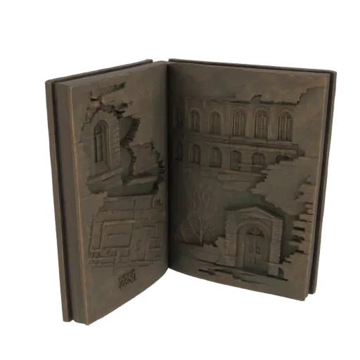 نموذج ثلاثي الأبعاد لكتاب برونزي مفتوح بنقوش بارزة مفصلة لمبانٍ مدمرة على صفحاته.