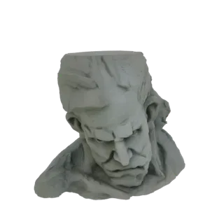 3D model of a distressed abstract sculpture of a human head, with rough textures and angular features, viewed from the front.