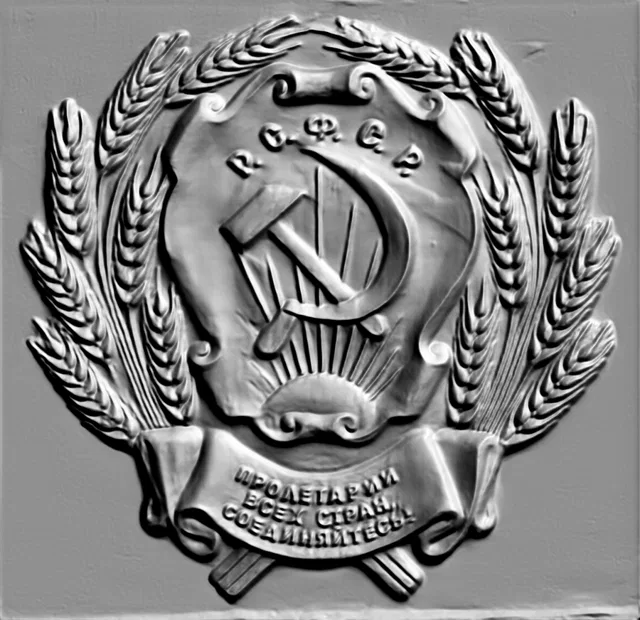 3D model of USSR Coat of Arms bas-relief with hammer and sickle, surrounded by wheat ears, with a motto on a ribbon.